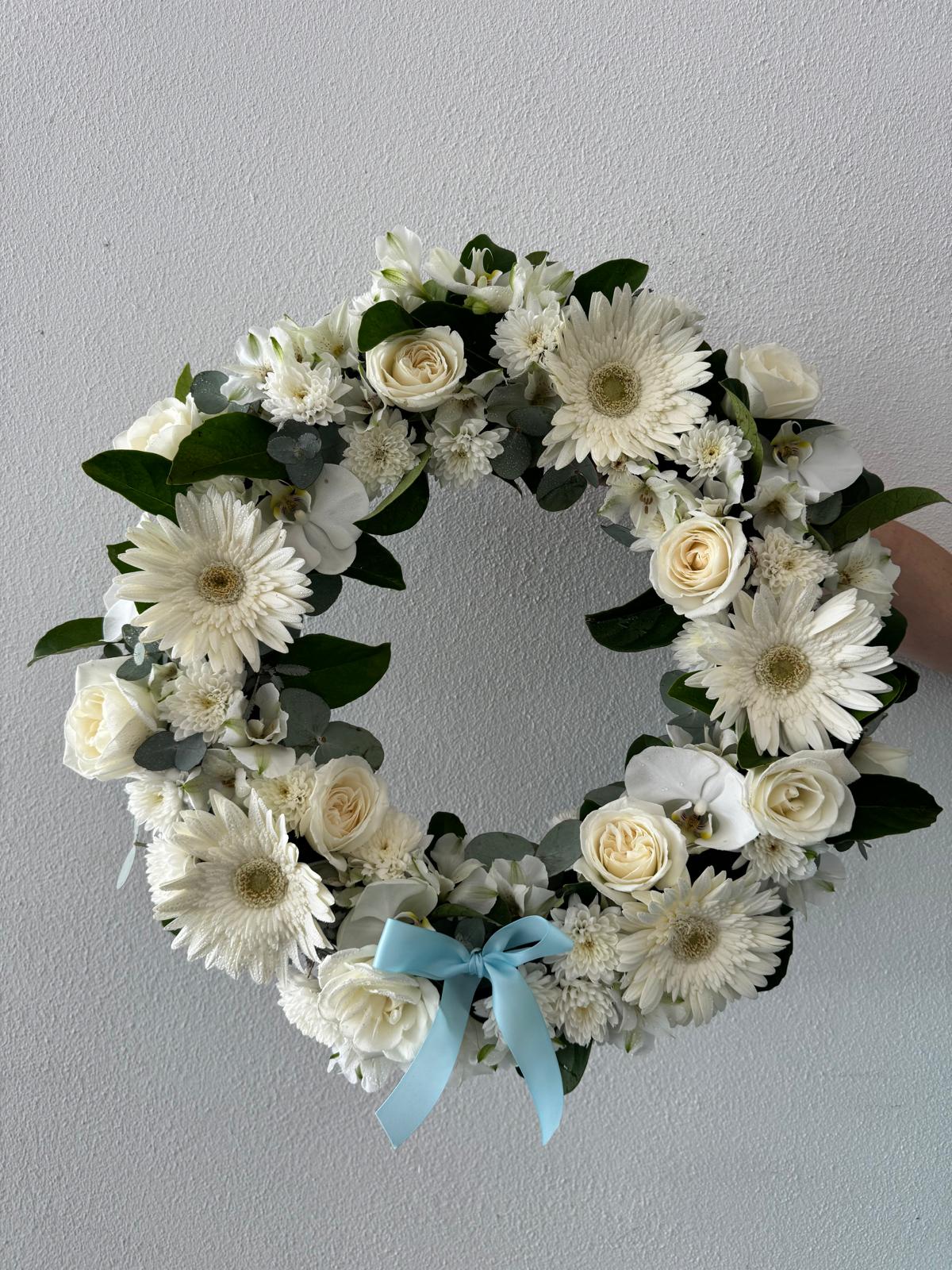Gardiose Wreath-A sizable floral wreath with a variety of white flowers, including roses and gerberas