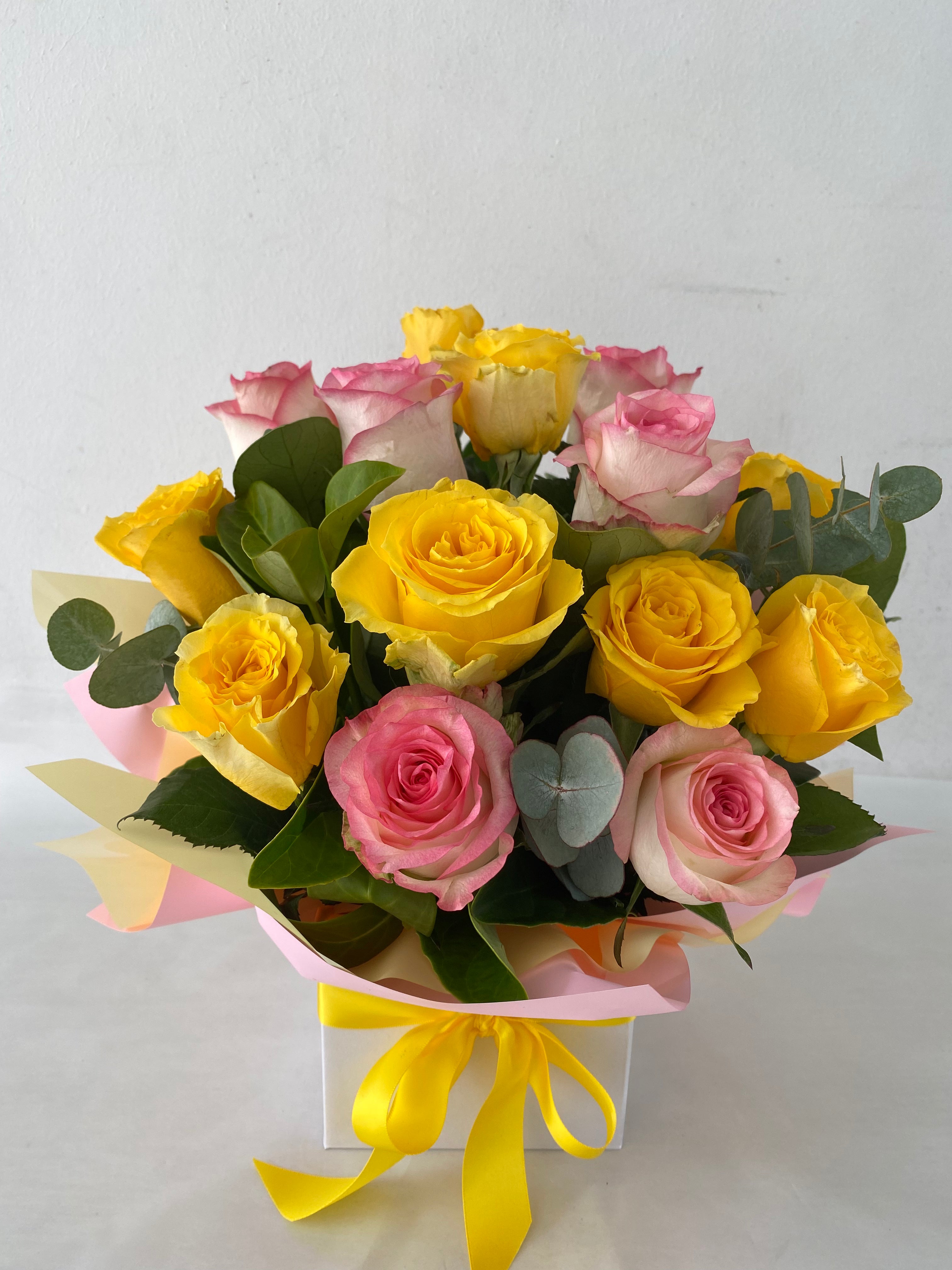 Sweet Sunshine-A bouquet of yellow and pink roses with greenery, presented in a box