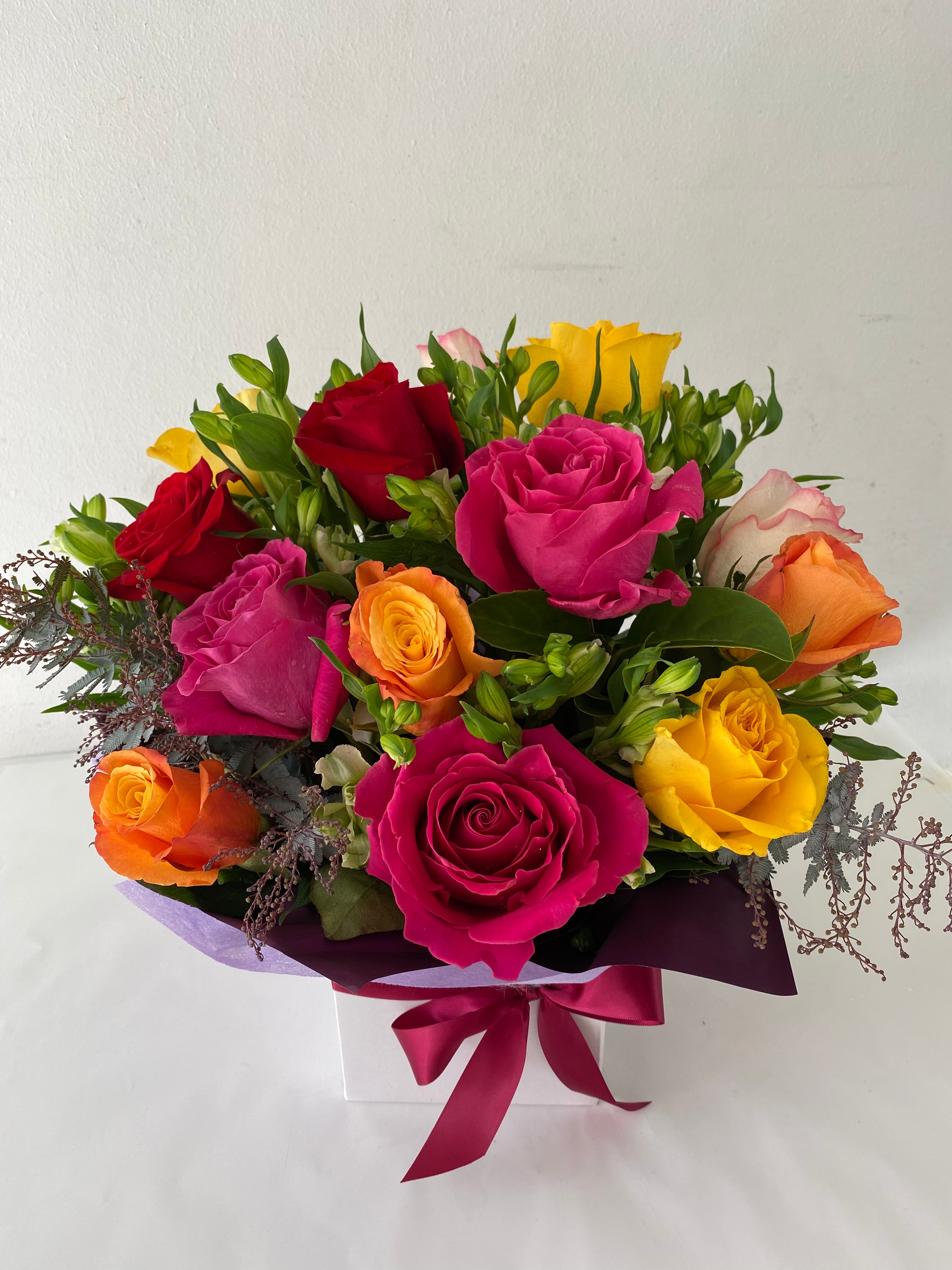Rose delight-A bouquet of mixed color roses with a red, pink, orange, and yellow roses prominently displayed